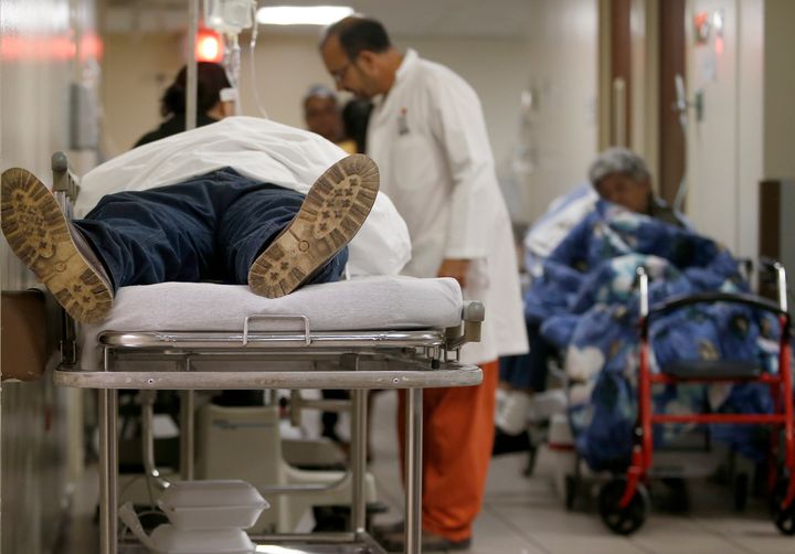 A patient lies in a hospital bed in the hallway inside the emergency room at the Grupo HIMA San Pablo hospital in Caguas, Puerto Rico, on Sept. 29, 2017.