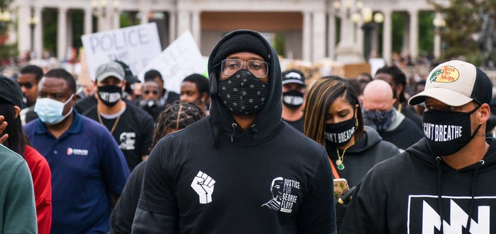 Von Miller leads the crowd at a protest on Saturday in Denver.