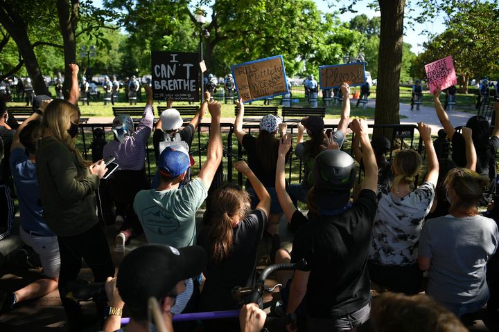 Protestors take a knee and raise their fists in Lafayette Square near the White House on June 1. The protesters were forced back with gas canisters and flash-bang grenades by officers called to the scene. 
