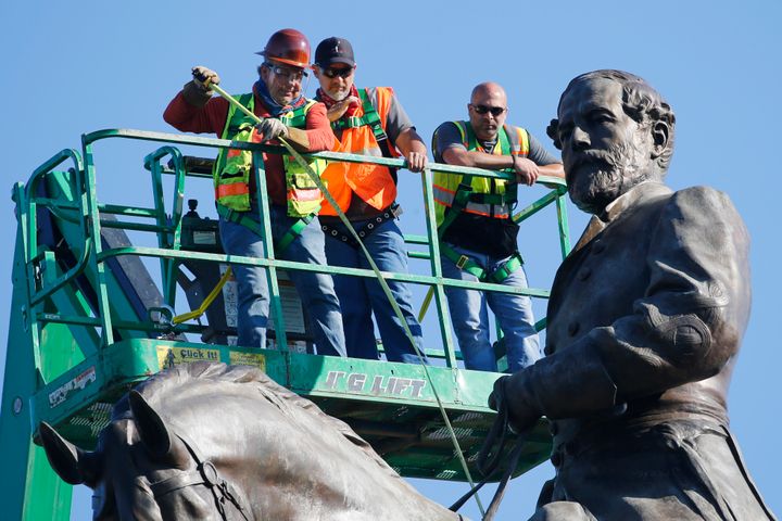 An inspection crew from the Virginia Department of General Services takes measurements as they inspect the statue of Confederate Gen. Robert E. Lee on Monument Avenue June 8, 2020, in Richmond, Virginia. Gov. Ralph Northam has ordered the removal of the statue. (AP Photo/Steve Helber)