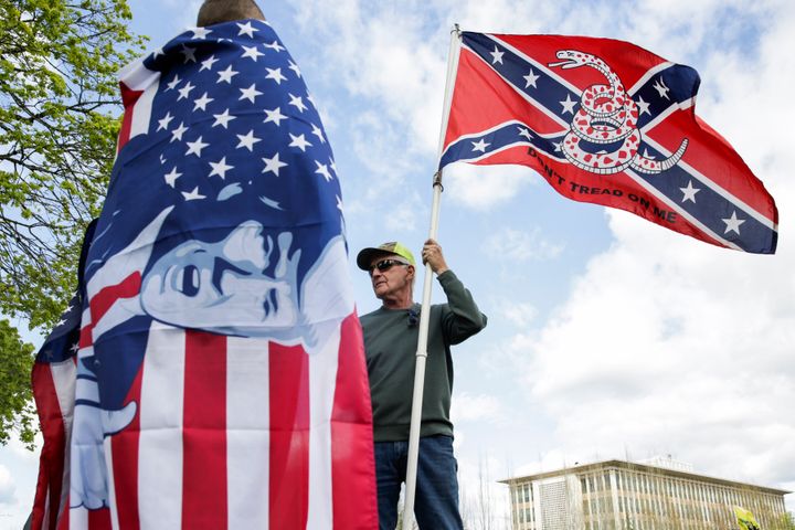 Keith Weber of Centralia, Washington holds a flag that combines a Gadsden flag from the American Revolution with a Confederate flag from the American Civil War.