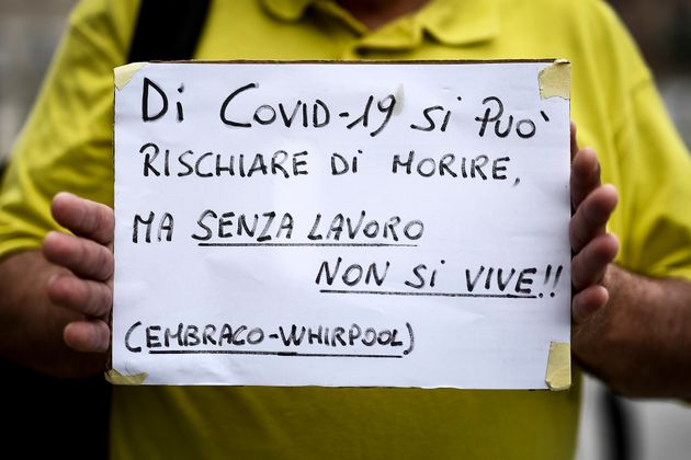 PIAZZA CASTELLO, TURIN, ITALY - 2020/06/04: A protester holds a placard reading 'Because of Covid-19...