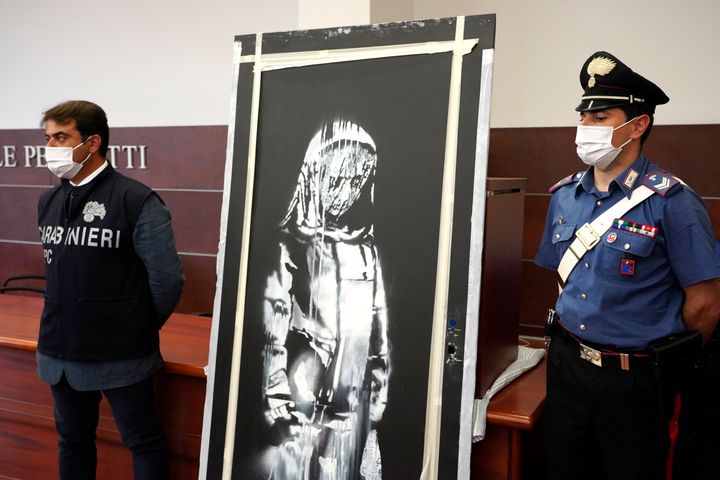 Italian authorities unveil a stolen artwork painted by Banksy as a tribute to the victims of the 2015 terror attacks at the Bataclan music hall in Paris.