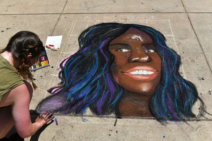 An artist drawing a portrait of Breonna Taylor in front of the Colorado State Capitol building in Denver on June 5.