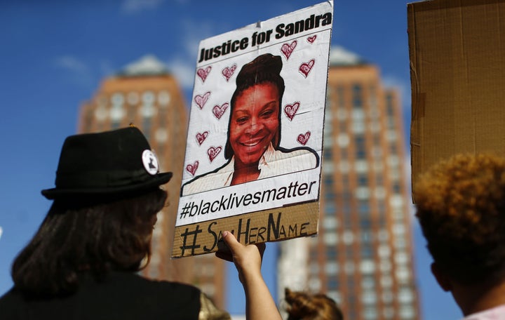 A woman holds a poster bearing the portrait of Sandra Bland in New York on Aug. 9, 2015.