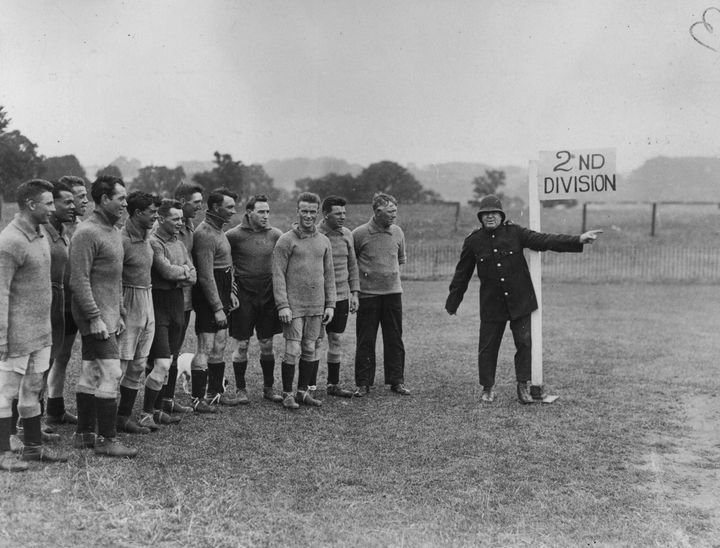 August 10 1926: Plymouth Argyle FC trainer Tommey Haynes as a points duty policeman directing the way to promotion. Leslie is seen second left.