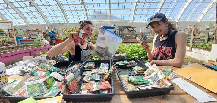 Inuvik Community Greenhouse staff pose with seeds donated by southern Canadians.