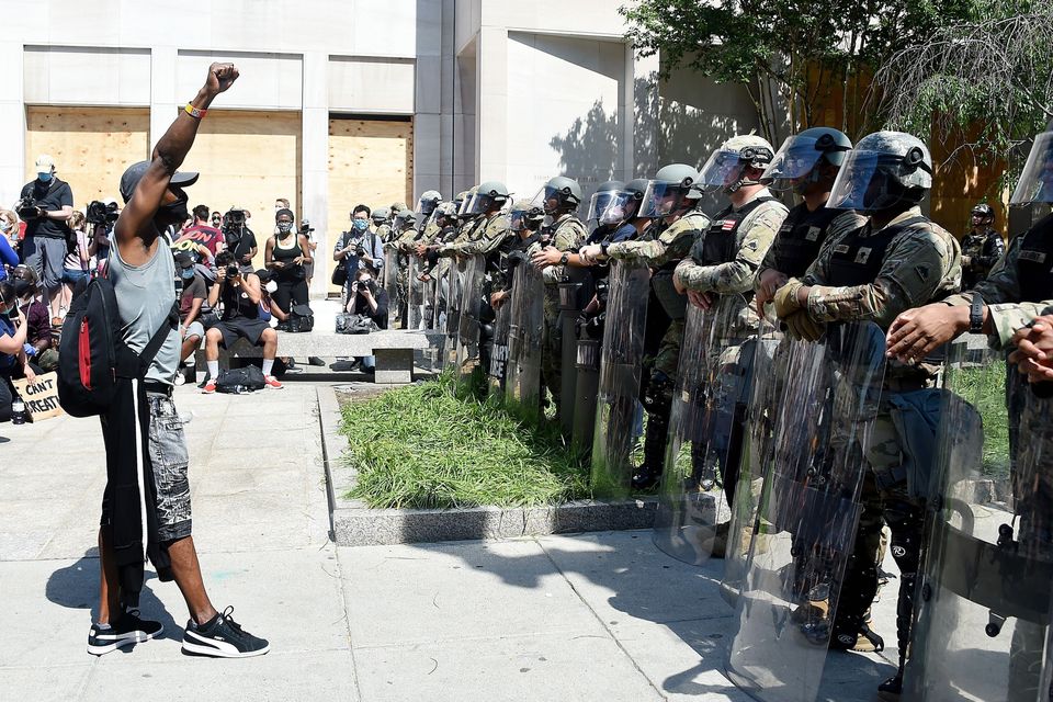 A protester faces military police near the White House to protest the death of George Floyd, on June 3 in Washington, D.C.