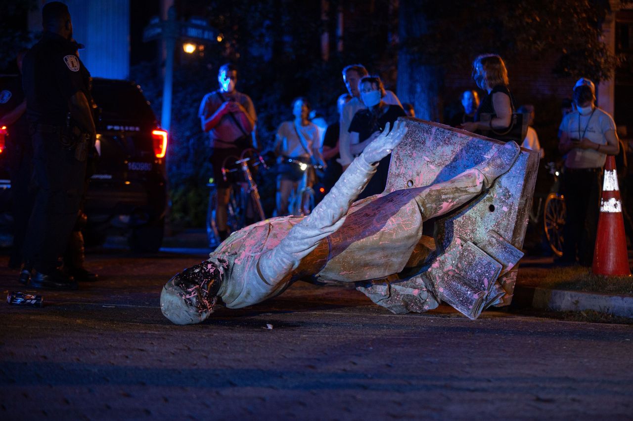 A statue of Confederacy President Jefferson Davis lies on the street after protesters pulled it down in Richmond, Virginia, on June 10.