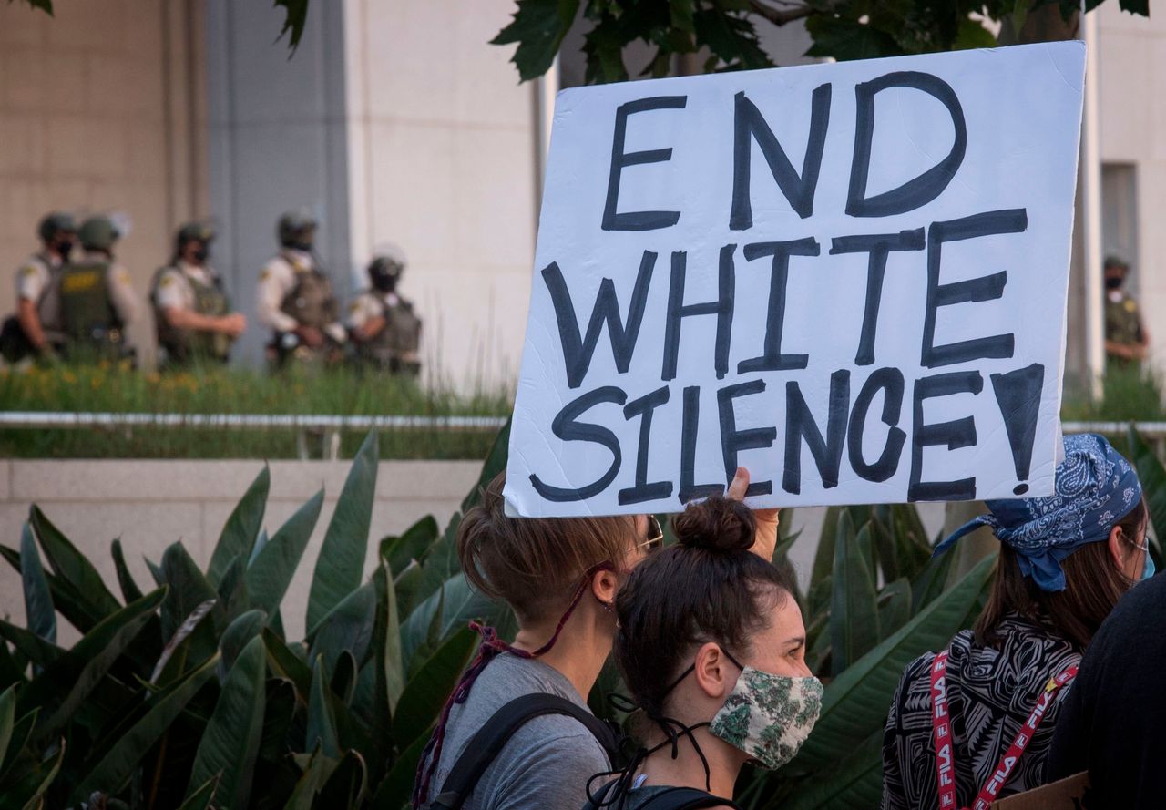Supporters of Black Lives Matter, hold signs during a protest outside the Hall of Justice as they demonstrate against the death of George Floyd, in Los Angeles, California on June 10, 2020. 