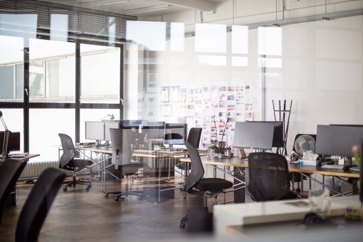 Interior of open office with desk and chairs. Modern office space interior.