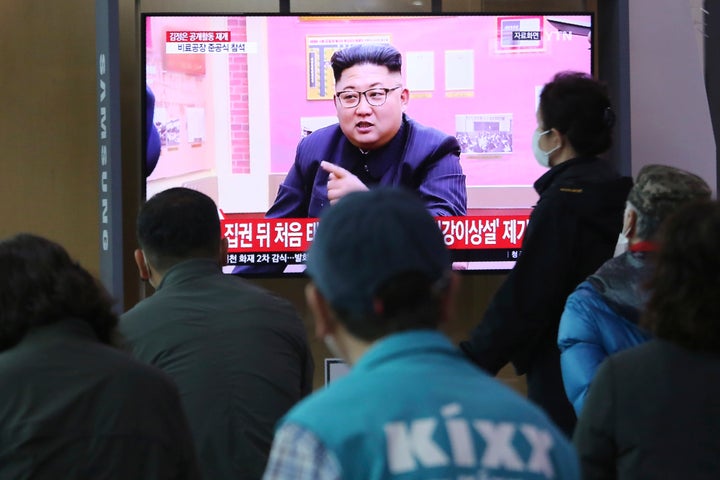 People watch a TV showing a file image of North Korean leader Kim Jong Un during a news program at the Seoul Railway Station