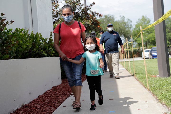 Flora Garcia arrives with her daughter Krislaya Trejo at the Florida Department of Health in Collier County to be tested for