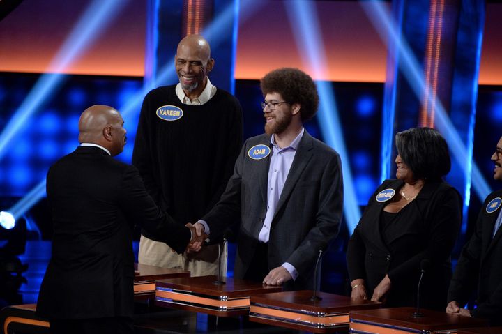 Adam Abdul-Jabbar, pictured with his famous father on "Celebrity Family Feud," shakes the hand of host Steve Harvey.