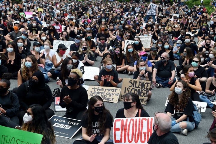 Anti-racism protesters sit outside the Connie Morella Library in Bethesda, Maryland, on June 2.