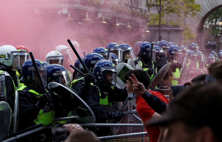 Counter-protestors clash with police as they gather against a Black Lives Matter demonstration following the death of George