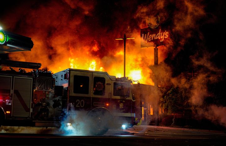 ATLANTA, USA - JANUARY 14: Demonstrators set on fire a restaurant during the protest after an Atlanta police officer shot and killed Rayshard Brooks, 27, at a Wendy's fast food restaurant drive-thru Friday night in Atlanta, United States on January 14, 2020. As nationwide protests slowed in the death of George Floyd, anger again erupted Saturday in the US over the fatal shooting of another black man. Mayor Keisha Lance Bottoms announced Atlanta Police Chief Ericka Shields voluntarily stepped down from the department earlier in the day. (Photo by Ben Hendren/Anadolu Agency via Getty Images)