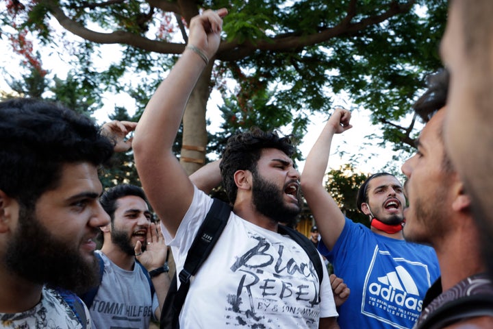 Anti-government protesters shout slogans in Beirut, Lebanon, Saturday, June 13, 2020. Lebanese protesters took to the streets in Beirut and other cities in mostly peaceful gatherings against the government, calling for its resignation as the small country sinks deeper into economic distress. (AP Photo/Hassan Ammar)