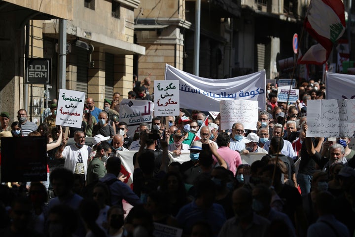 Anti-government protesters shout slogans against the government in Beirut, Lebanon, Saturday, June 13, 2020. (AP Photo/Hassan