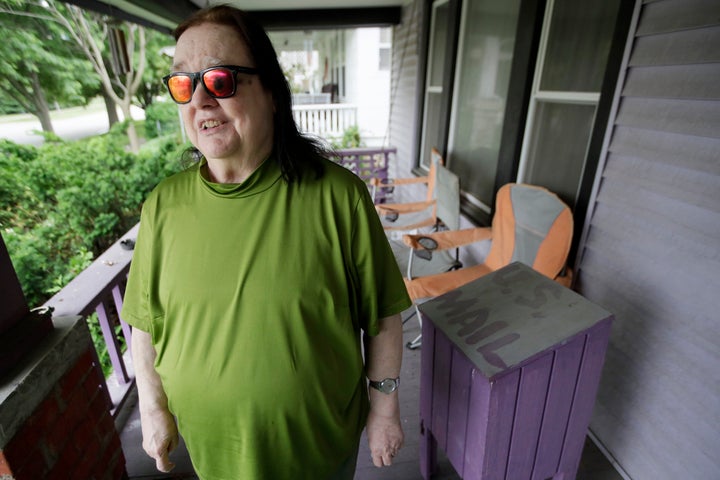 In this Wednesday, May 27, 2020, photo, Ann Byington stands next to the mail box at her home in Topeka, Kan. Blind voters like Byington fear a loss of control over their ability to cast a ballot as election officials across the U.S. plan a major expansion of voting by mail amid the coronavirus pandemic. (AP Photo/Orlin Wagner)