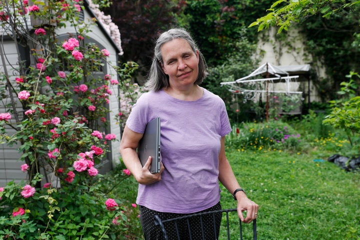 In this May 28, 2020, photo, Tracy Carcione, a 59-year-old computer programmer who is blind, poses for a photograph at her home in Teaneck, N.J. Blind voters fear a loss of control over their ability to cast a ballot as election officials across the U.S. plan a major expansion of voting by mail amid the coronavirus pandemic. (AP Photo/Kathy Willens)