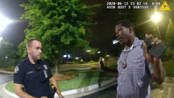 This screen grab taken from body camera video provided by the Atlanta Police Department shows Rayshard Brooks speaking with Officer Garrett Rolfe in the parking lot of a Wendy's restaurant, late Friday, June 12, 2020, in Atlanta. Rolfe has been fired following the fatal shooting of Brooks and a second officer has been placed on administrative duty. (Atlanta Police Department via AP)