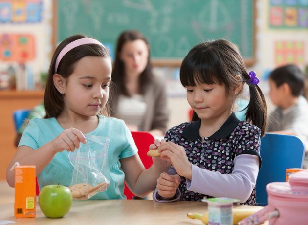 Girls eating lunch together in classroom