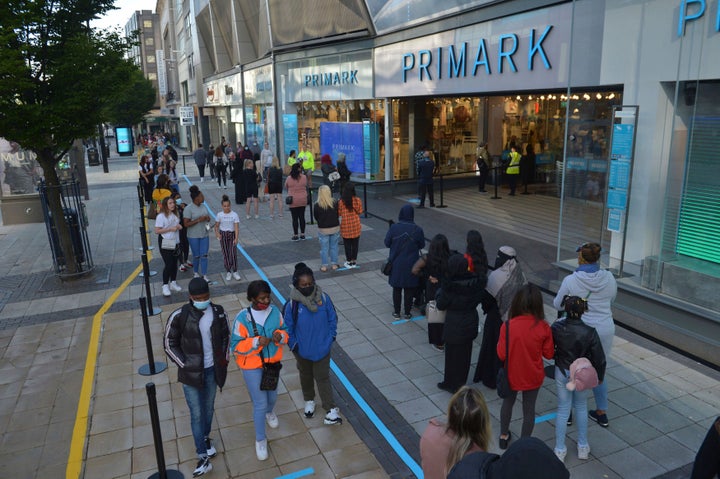 Shoppers queue up outside Primark as it reopened, in Birmingham, England, Monday June 15, 2020. 