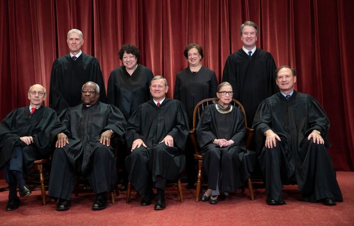 Conservative justices Neil Gorsuch (top row, far left) and Chief Justice John Roberts (bottom row, center) joined the court's four liberal justices in the majority.