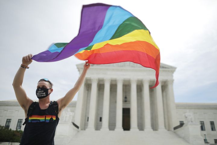 Joseph Fons holds a Pride Flag while standing in front of the U.S. Supreme Court building on Monday, after the court ruled that LGBTQ people can not be disciplined or fired based on their sexual orientation. With Chief Justice John Roberts and Justice Neil Gorsuch joining the Democratic appointees, the court ruled 6-3 that the Civil Rights Act of 1964 bans bias based on sexual orientation or gender identity.