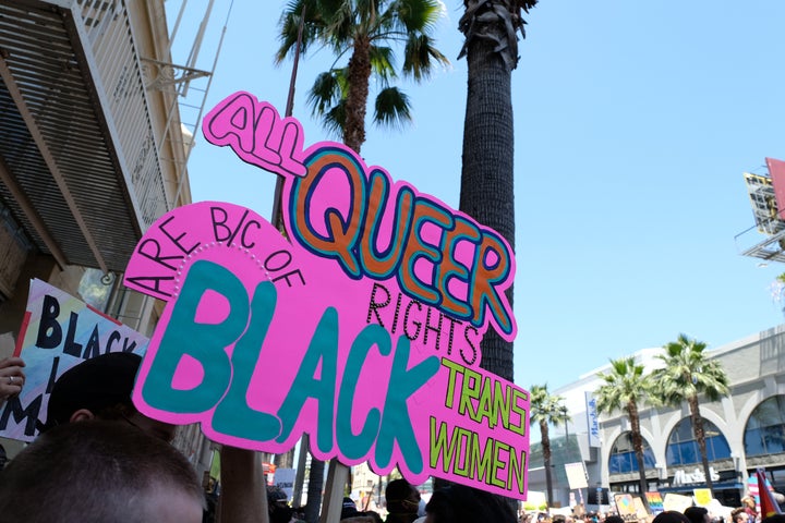 A sign reading "All queer right are because of Black trans women" is seen at the All Black Lives Matter Solidarity March on Sunday in Los Angeles.