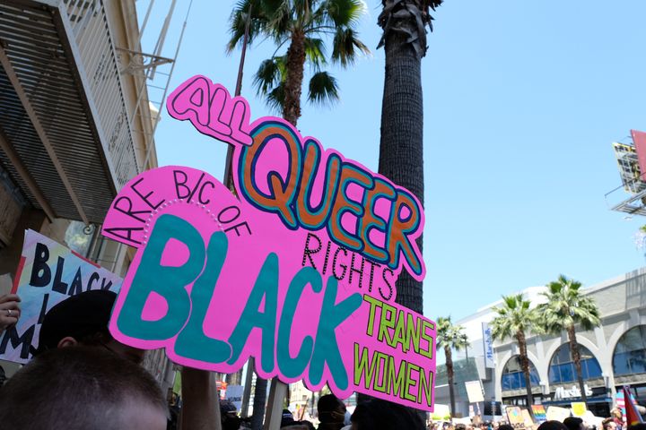 A sign reading "All queer right are because of Black trans women" is seen at the All Black Lives Matter Solidarity March on Sunday in Los Angeles.