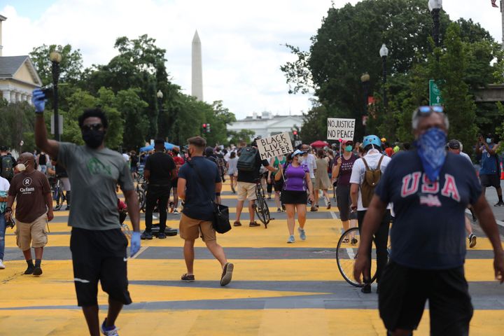 With the Washington Monument looming in the background, protesters march for racial justice on the streets of the District of Columbia near the White House on June 5.