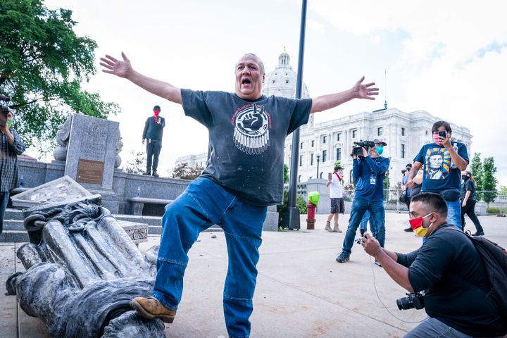 Mike Forcia, of the Black River Anishinabe, celebrated after the Christopher Columbus statue was toppled in front of the Minnesota State Capitol in St. Paul, Minnesota.