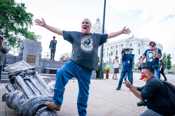 Mike Forcia, of the Black River Anishinabe, celebrated after the Christopher Columbus statue was toppled in front of the Minnesota State Capitol in St. Paul, Minnesota.