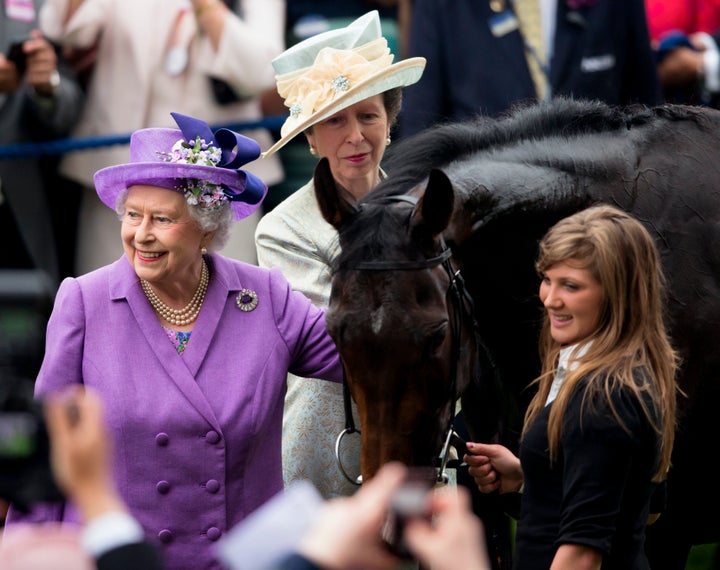 Princess Anne looks on as Queen Elizabeth II pats her Gold Cup winning horse Estimate on Ladies Day of Royal Ascot on June 20, 2013 in Ascot, England.