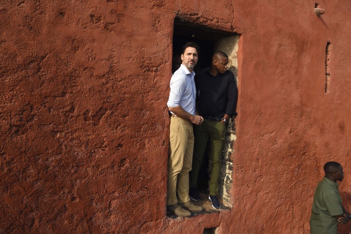 Prime Minister Justin Trudeau speaks with Toronto Raptors president Masai Ujiri at the "Door of the Journey of No Return" at the Goree Slave House during a visit to Senegal on Goree Island off the coast of Dakar on Feb. 12, 2020.