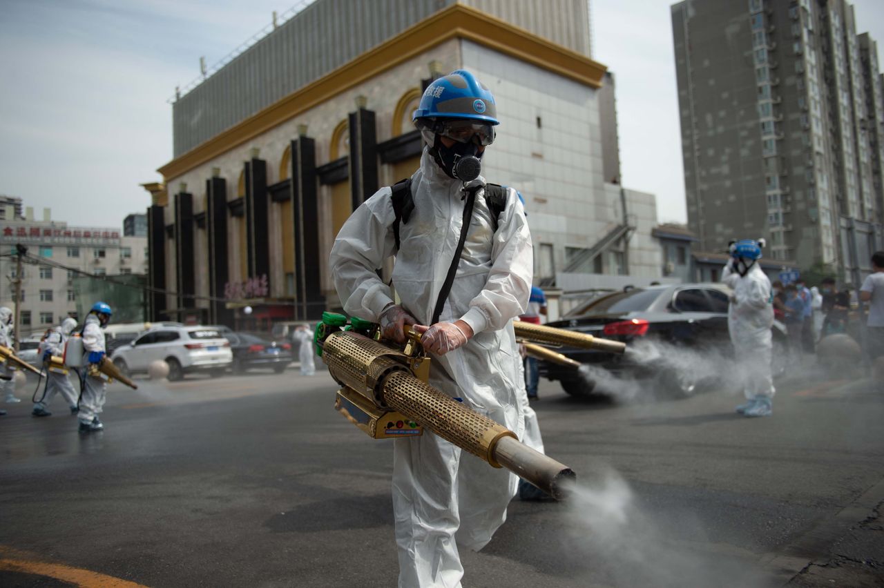 Workers disinfect the Yuegezhuang wholesale market in Beijing on June 16, 2020, following a coronavirus outbreak.