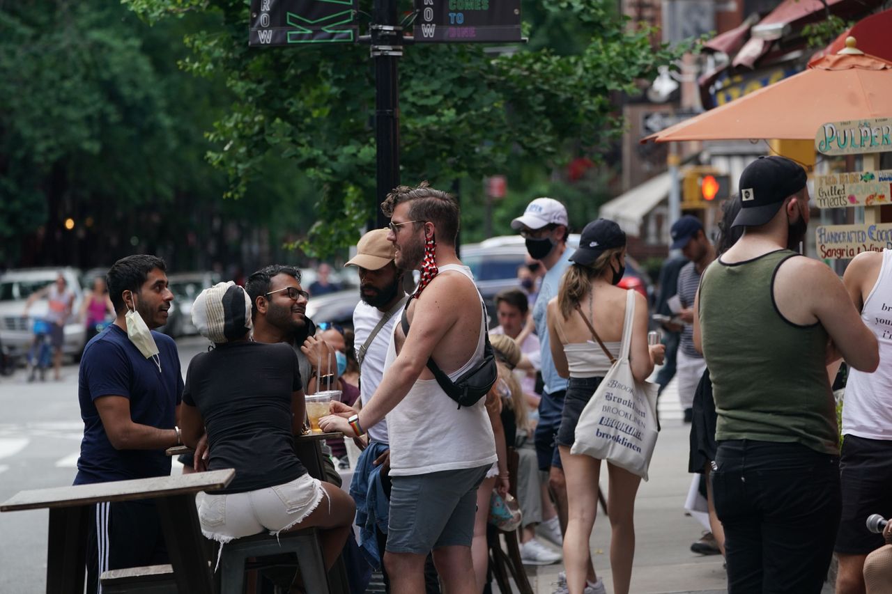 People drink outdoors at bars and restaurants in the Hells Kitchen neighborhood of New York on June 7, 2020.