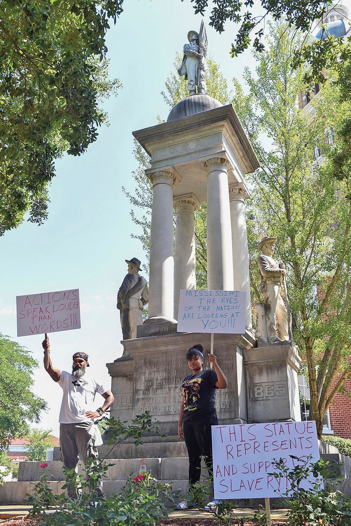 John Lewis, left, and Sonniah Ramirez, 12, protest for the removal of the Confederate monument that stands on the Lowndes County Courthouse lawn, Monday, June 15, 2020 in Columbus, Miss.