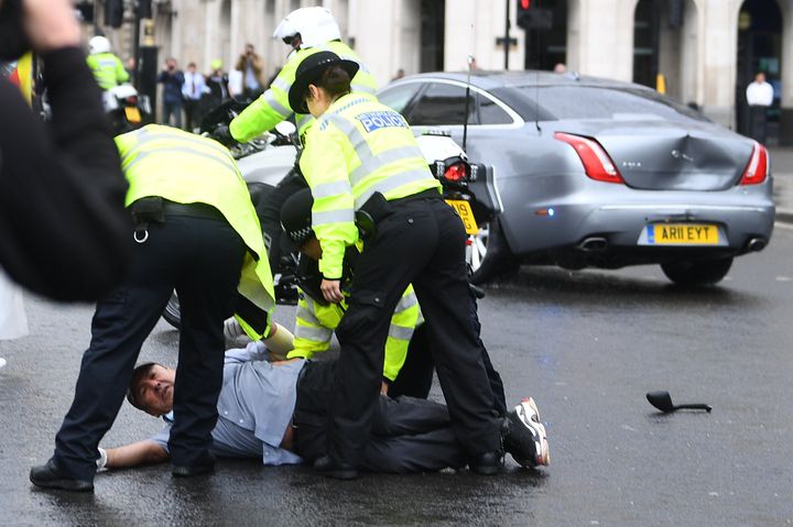 Police detain a man after he ran in front of Prime Minister Boris Johnson's car as it left the Houses of Parliament, Westminster. (Photo by Victoria Jones/PA Images via Getty Images)