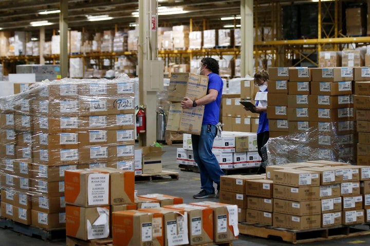 Workers carry boxes at Oklahoma's Strategic National Stockpile warehouse in Oklahoma City in April. States spent billions of dollars stocking up on medical supplies such as masks and breathing machines during the coronavirus pandemic.