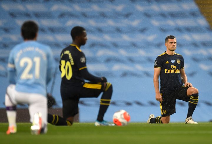 <strong>Granit Xhaka of Arsenal takes a knee in support of the Black Lives Matter movement prior to the Premier League match between Manchester City and Arsenal.</strong>