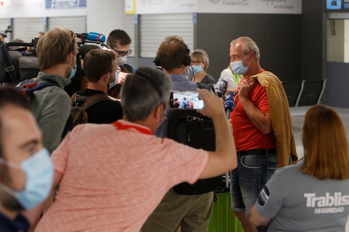 Travelers from Germany speak to the press upon arrival at Palma de Mallorca Airport on June 15, the day the pilot plan for the reopening of tourism begins in the Balearic Islands.