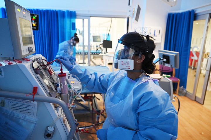 Members of the clinical staff wearing Personal Protective Equipment PPE care for a patient with coronavirus in the intensive care unit at the Royal Papworth Hospital in Cambridge.
