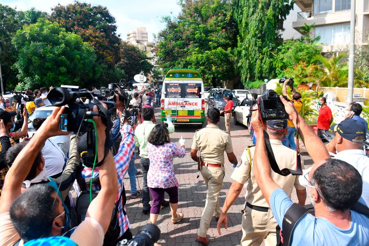 Media seen as an ambulance carrying the body of actor Sushant Singh Rajput is leaves his residence in Mumbai on June 14, 2020.