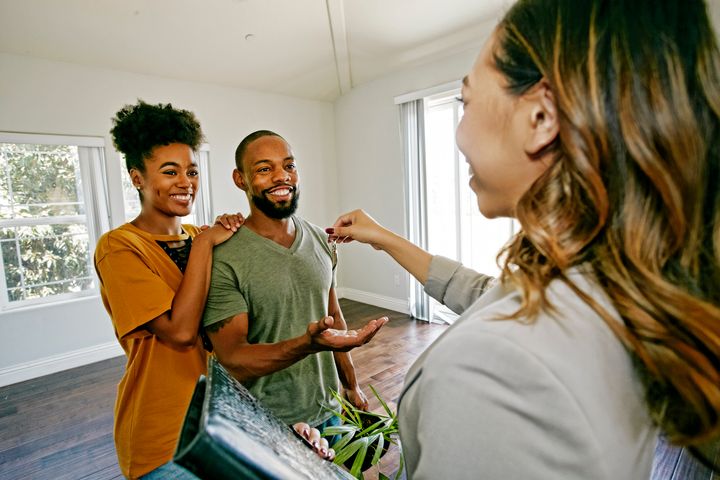 A young couple receives the keys to their new apartment in this undated stock photo. Some provinces have programs available specifically intended to help first-time homebuyers enter the housing market.