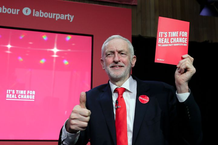 Jeremy Corbyn, former leader of the Labour Party, gives a thumbs up holding a copy of the 2019 manifesto.