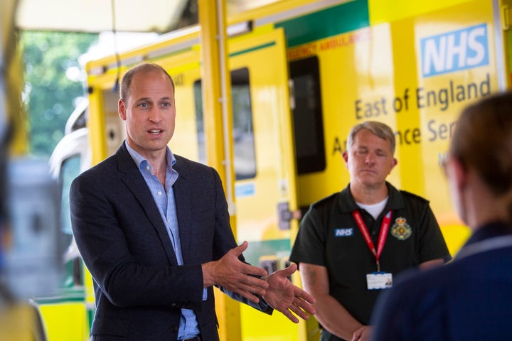 Prince William meets paramedic staff while maintaining social distancing during a visit to the ambulance station in King's Lynn, England, on Tuesday.