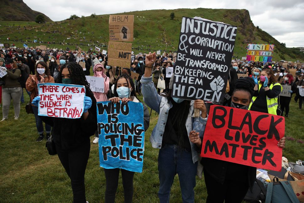 People take part in a Black Lives Matter protest rally in Holyrood Park, Edinburgh, on June 7